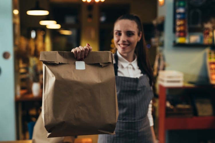 femme avec sac de vente a emporter